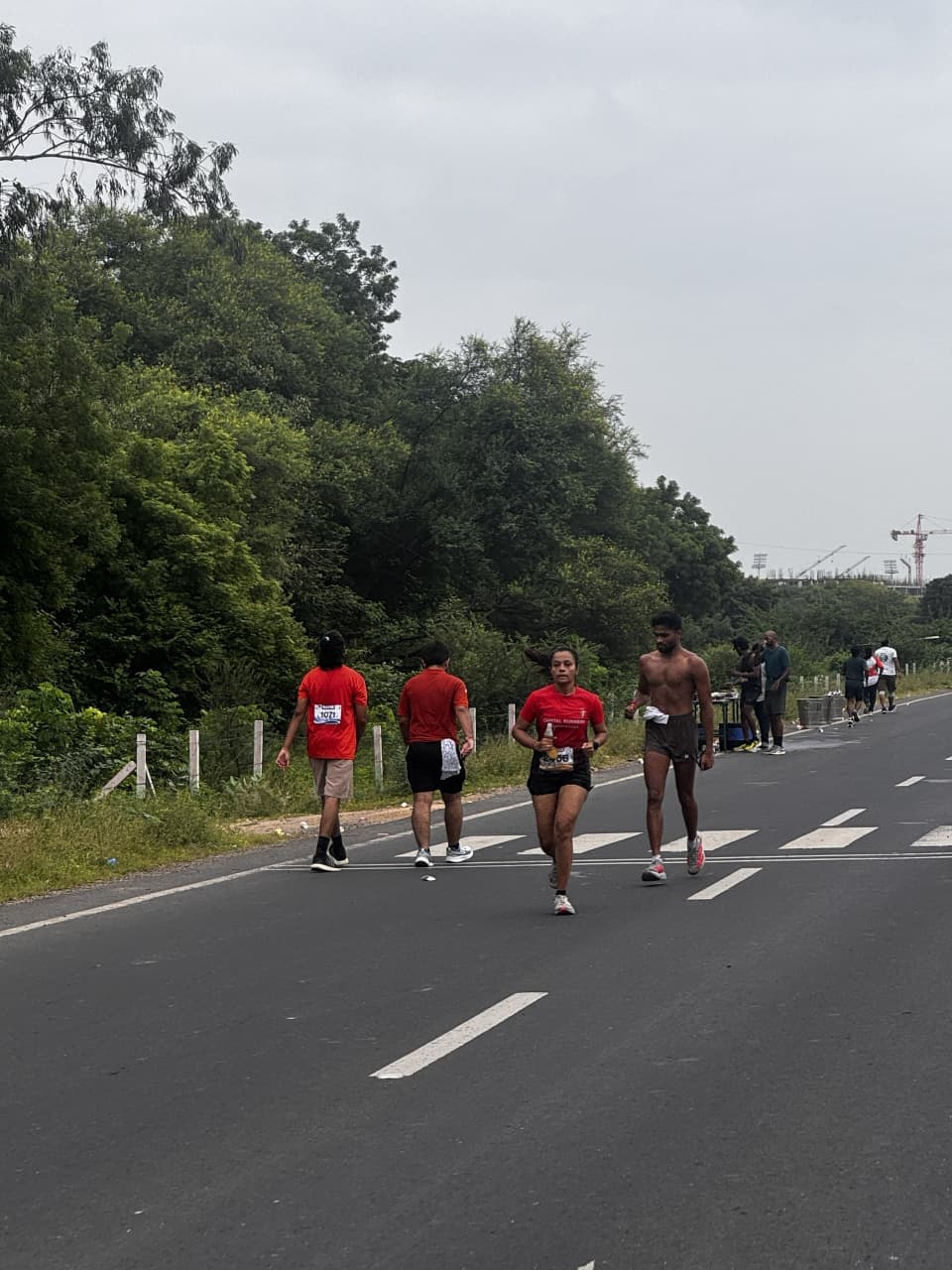 Ananta Run participants running and walking along the tree-lined course at IIT Gandhinagar.